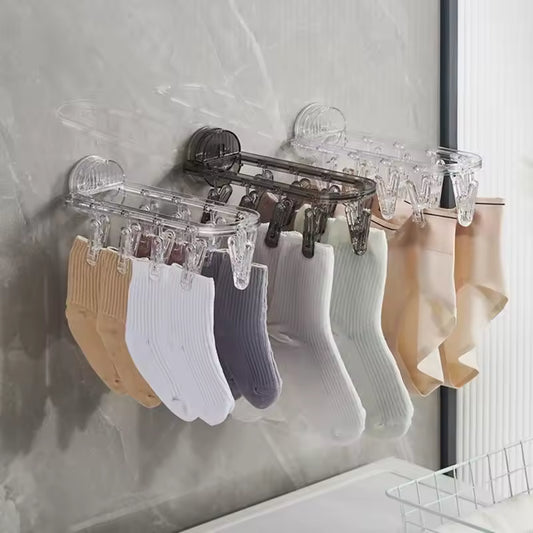 Clarify.pk suction clothes hanger rack with multiple clips holding various socks and hosiery on a wall