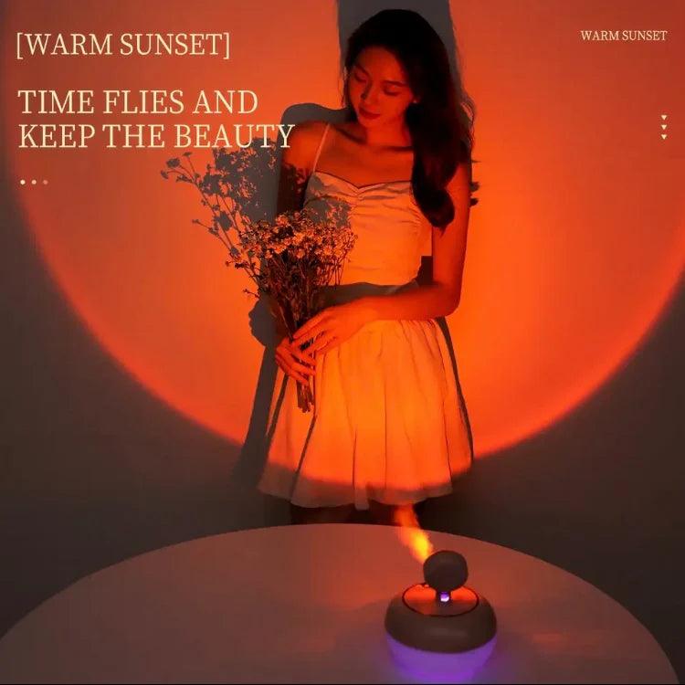 Woman holding flowers next to a sunset light humidifier casting warm orange light on the wall