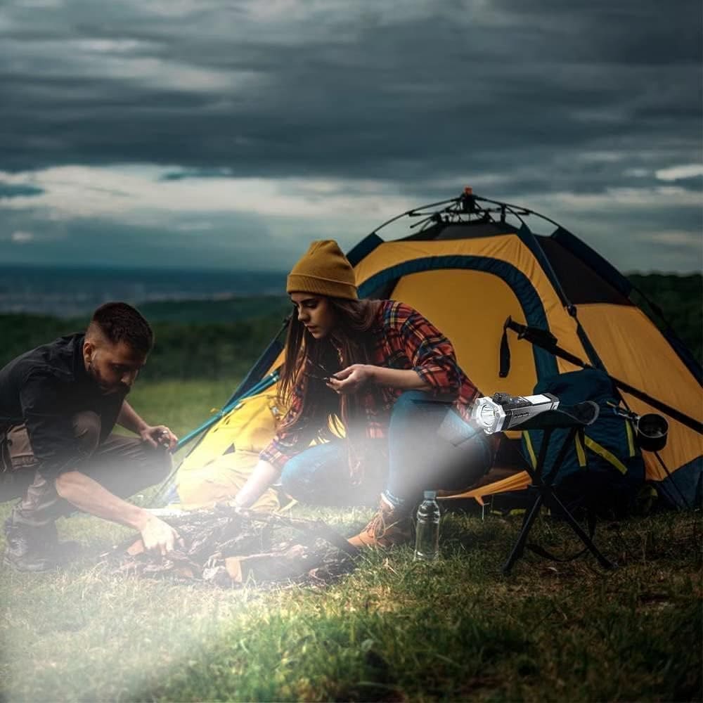 Camping scene with a couple using a super bright led flashlight near a yellow and blue tent