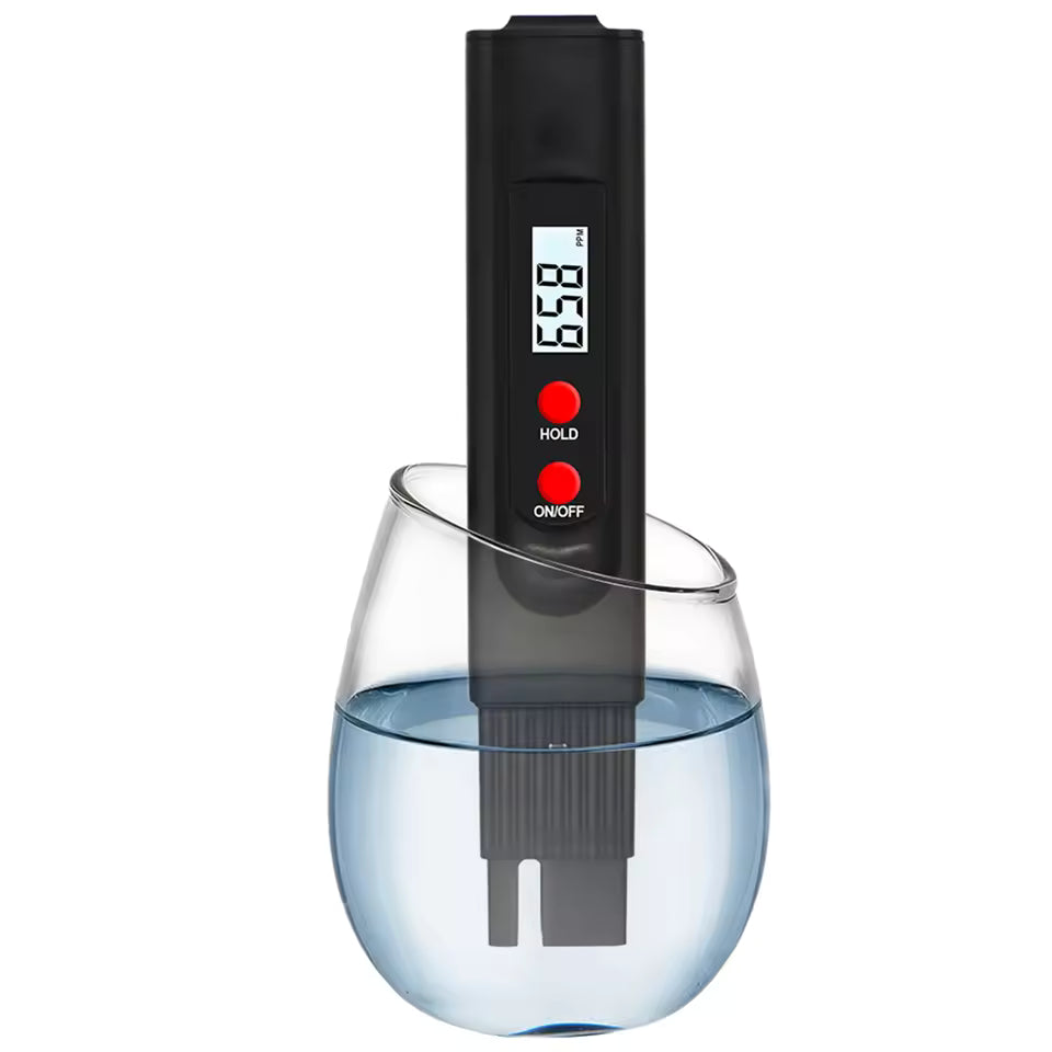 Black Clarify.pk handheld TDS meter for water testing in a glass of clear water with digital display