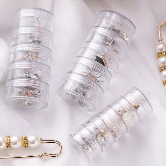 Clear 5 layer jewelry storage box by Clarify.pk holding various earrings and small accessories