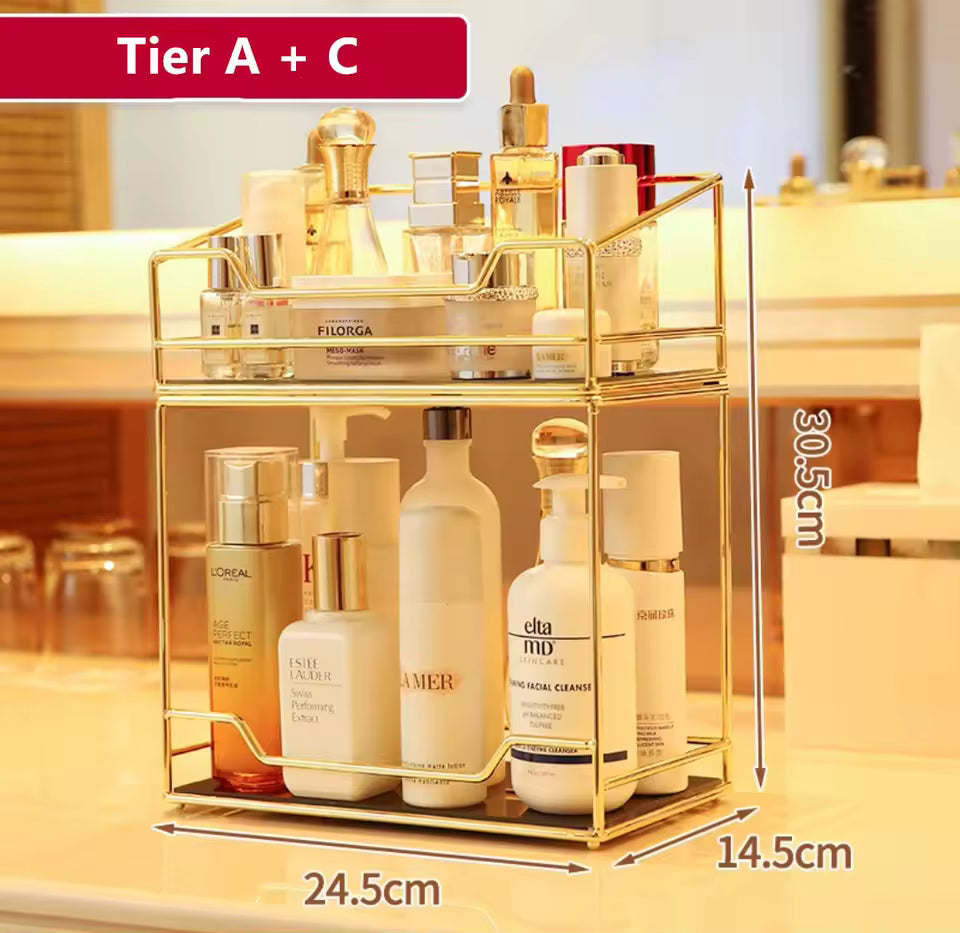 Clarify.pk gold desktop makeup organizer rack with two tiers holding various skincare bottles and cosmetics