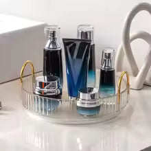 Clarify.pk 360 rotating makeup organizer holding various skincare and makeup bottles on a vanity