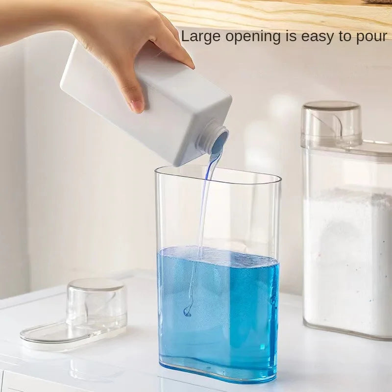 Transparent laundry detergent dispenser being filled with blue liquid detergent showing easy pour and large opening