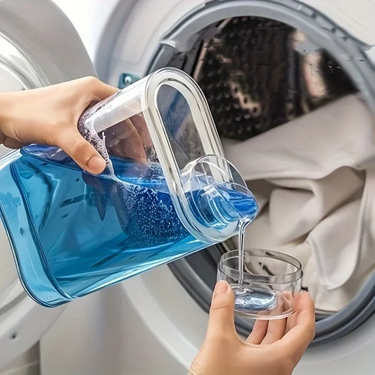 Hand pouring blue liquid from transparent laundry detergent dispenser into measuring cup near washing machine