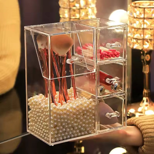 Clear multi-functional cosmetic organizer with pearl base holding brushes and three drawers for makeup storage