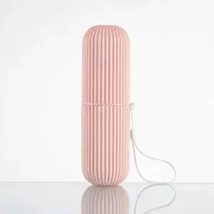 Pink travel toothpaste storage case with ribbed texture and a wrist strap for easy carrying