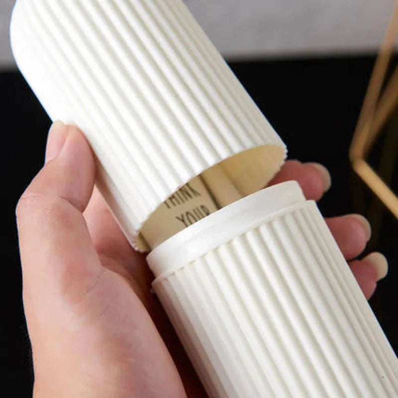 Hand holding white ribbed travel toothpaste storage case with removable lid for easy access