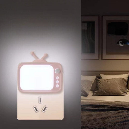 Clarify.pk tv shape night light glowing softly mounted on wall near bed with pillows
