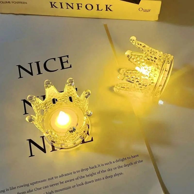 Transparent plastic crown night light decor glowing with warm yellow light on a table