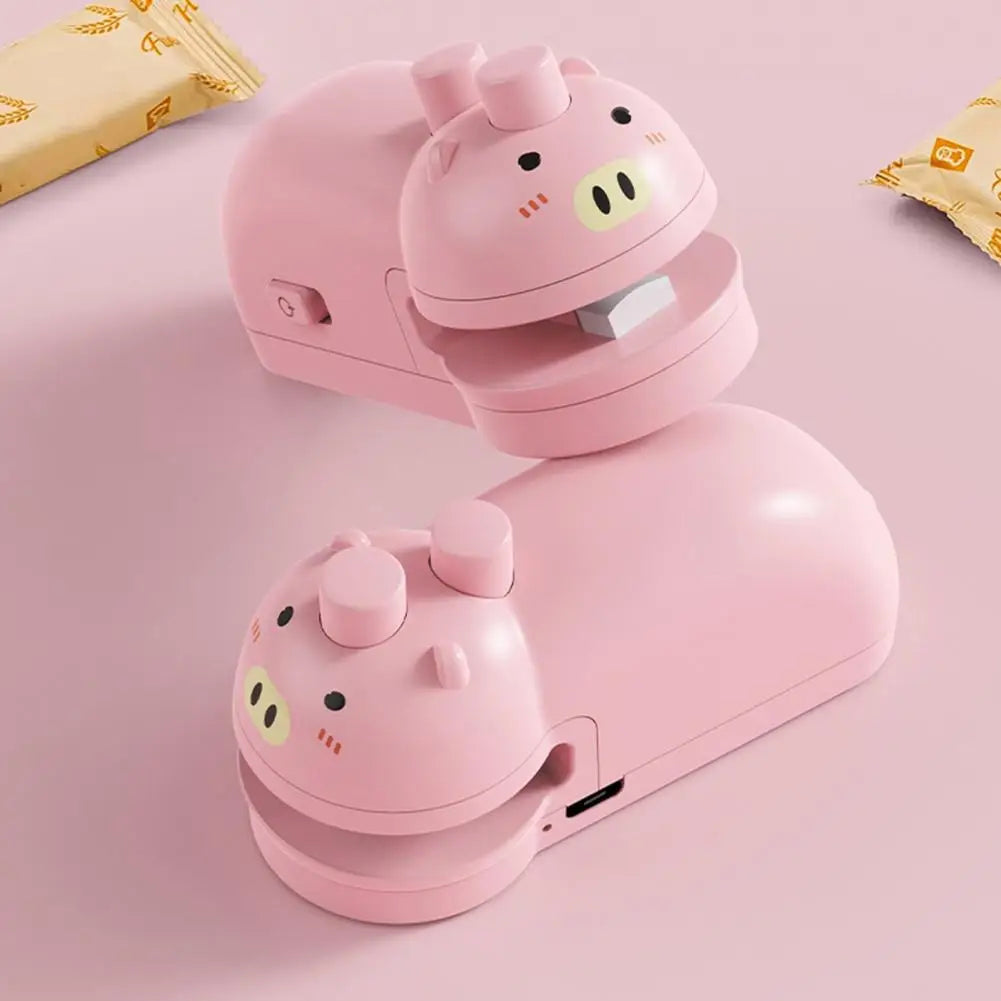 Pink pig-shaped handheld food sealing device by Clarify.pk for sealing snack bags