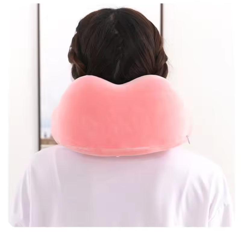 Pink U shaped memory foam neck pillow worn around the neck for travel comfort