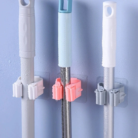 Clarify.pk broom mop wall clips in white pink and gray holding cleaning tools on blue wall