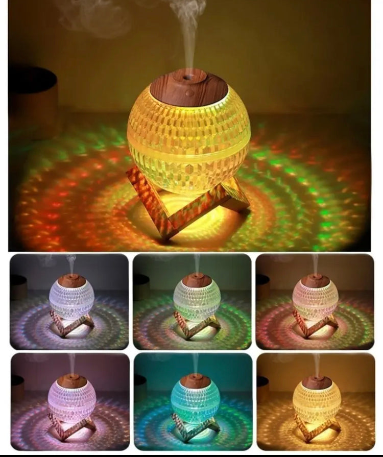 USB portable fragrance diffuser with colorful LED lights and wooden top emitting mist on a wooden stand