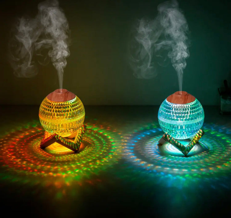 Clarify.pk USB portable fragrance diffuser glowing in yellow and blue with mist and colorful light patterns