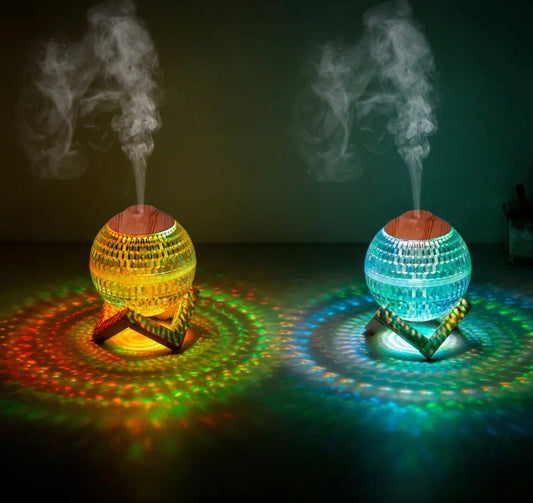 Clarify.pk USB portable fragrance diffuser glowing in yellow and blue with mist and colorful light patterns