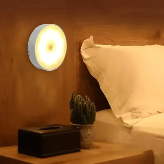 USB rechargeable closet lamp mounted on wooden wall beside bed with night light glow