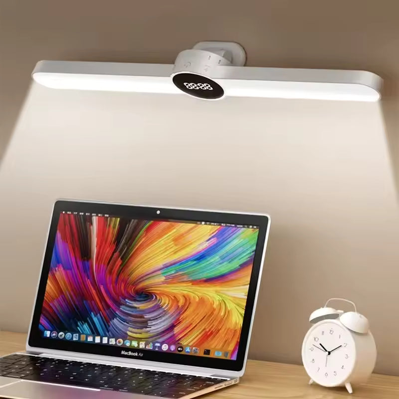 USB rechargeable LED desk lamp mounted above a laptop and white alarm clock on a wooden desk