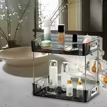 Clarify.pk black metal bathroom shelves with vanity countertop storage tray holding skincare bottles and cosmetics