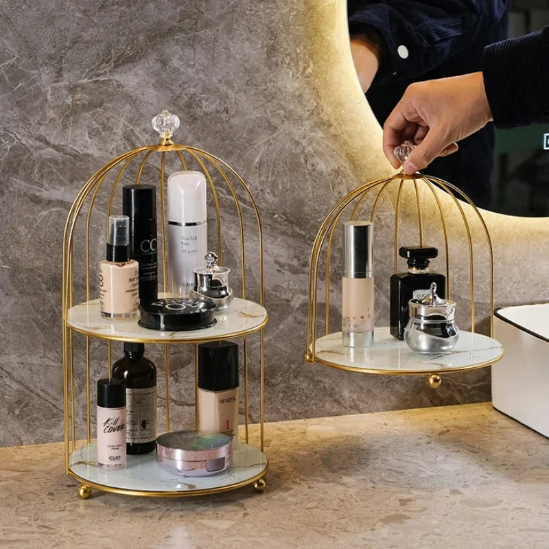 Clarify.pk elegant 2 tier cosmetic storage rack with gold frame and marble shelves holding makeup bottles