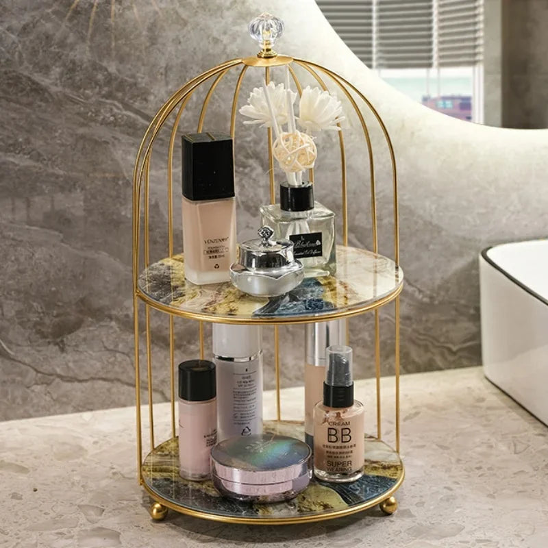 Elegant 2 tier cosmetic storage rack with gold frame and marble shelves holding makeup and perfume bottles