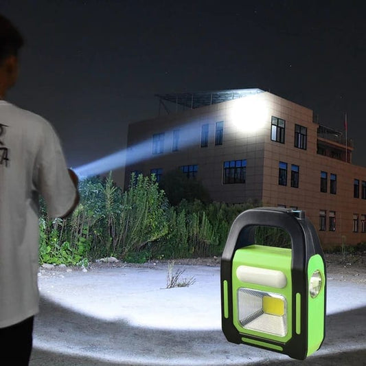 3 in 1 solar flashlight with spotlight handheld in use shining bright light on building at night