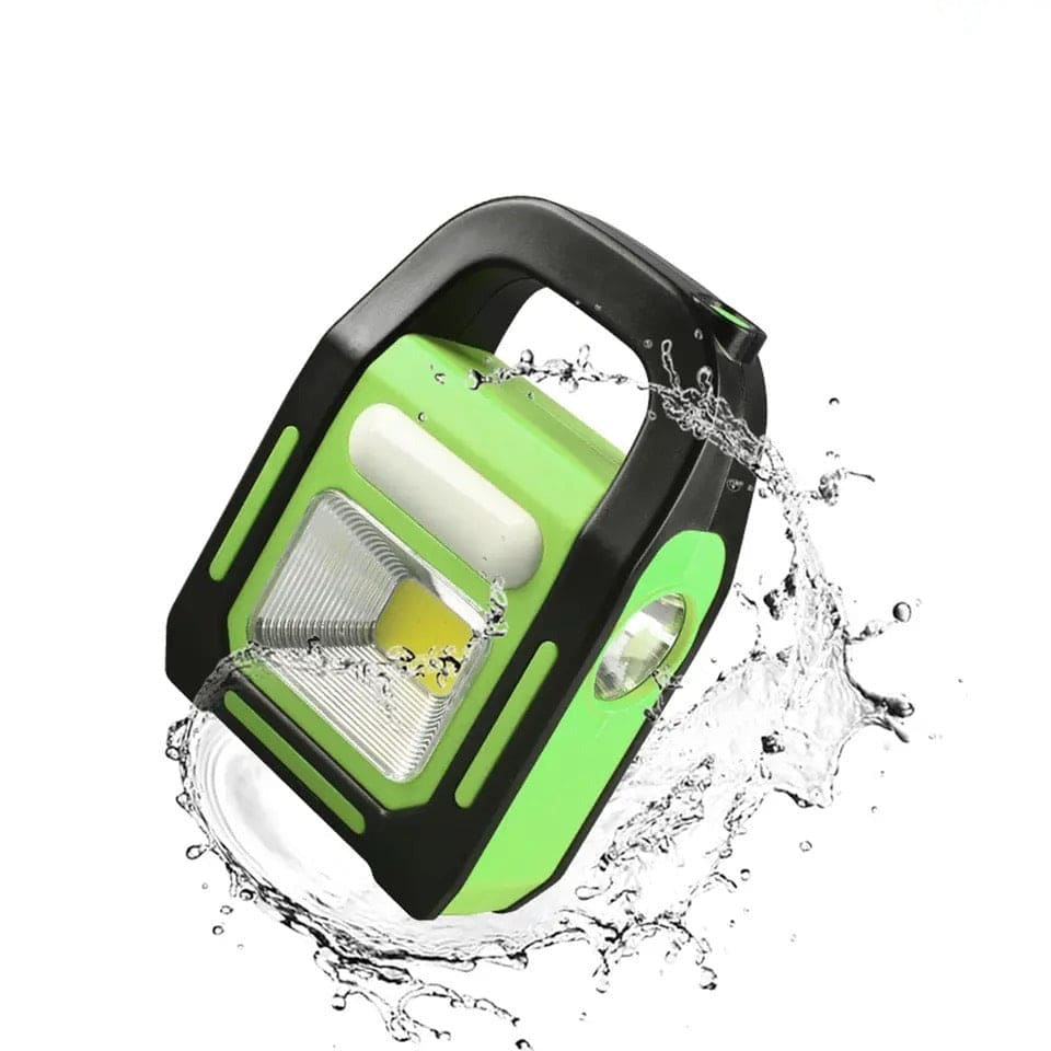 3 in 1 solar flashlight with spotlight in green and black, shown with water splash highlighting waterproof feature