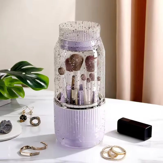 Clarify.pk brushes stored in a purple 360 degree makeup organizer with water droplets on a white surface