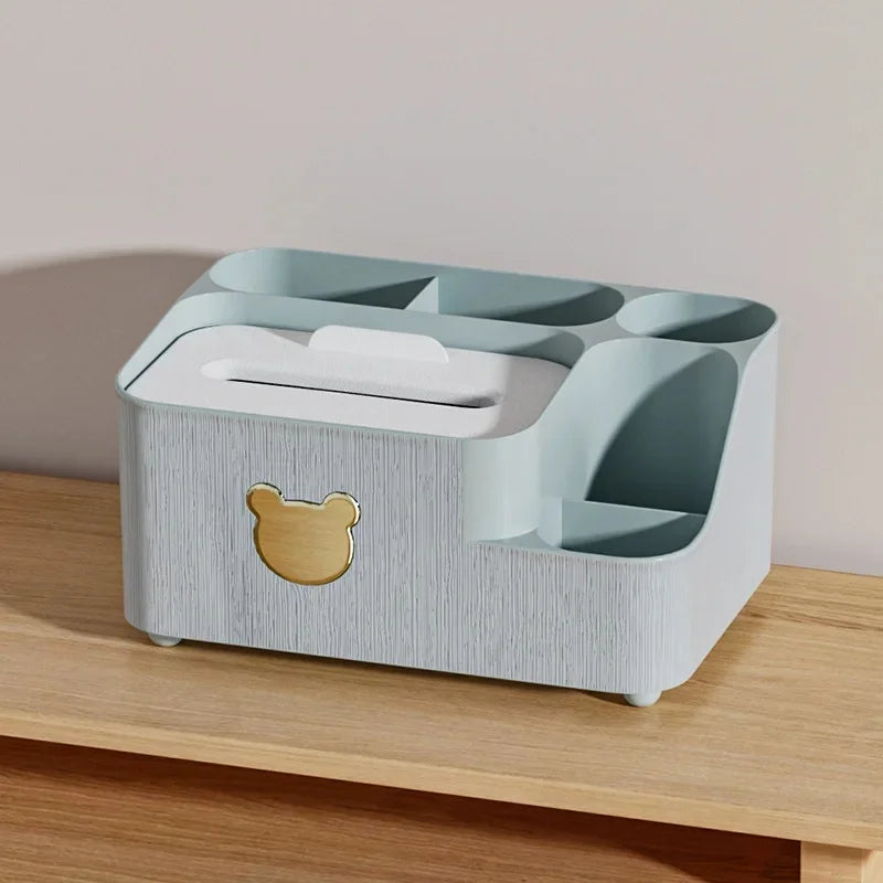 Gray plastic cartoon bear tissue box organizer with multiple compartments on wooden surface