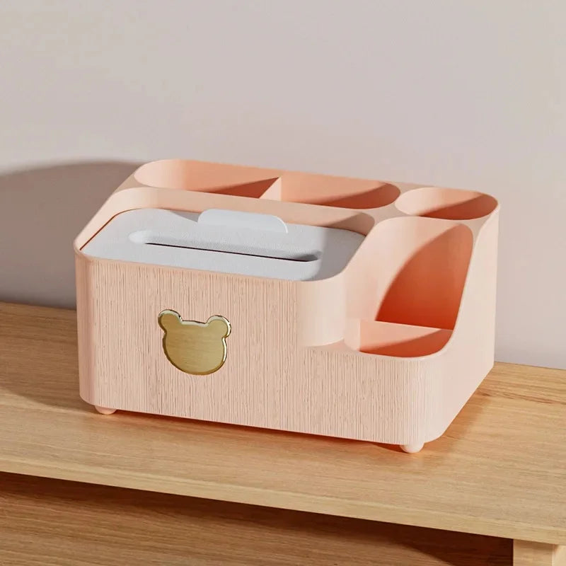 Peach color plastic cartoon bear tissue box organizer with multiple compartments on wooden surface