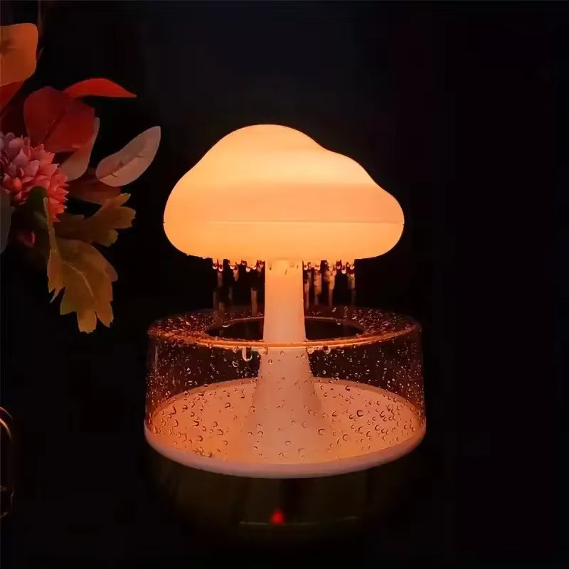 Colorful mushroom cloud humidifier emitting warm light with water droplets on base in dark setting