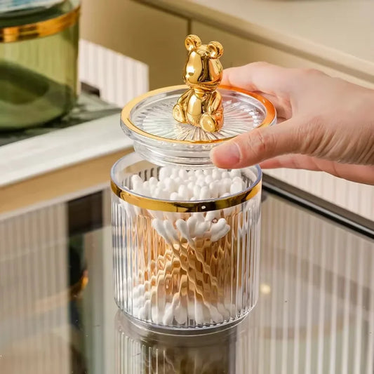 Cute cotton swab storage box with gold bear lid and clear ribbed glass body holding cotton swabs