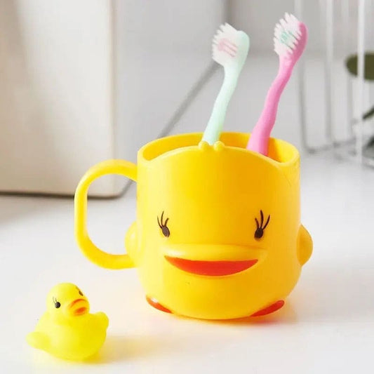 Cute duck toothbrush cup in yellow holding two toothbrushes with small rubber duck beside it
