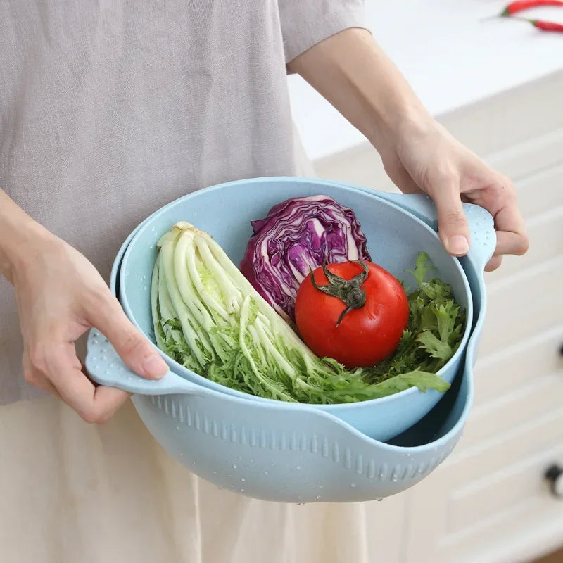 Hands holding a blue double layer fruit and vegetable basket with fresh tomato, lettuce, and cabbage
