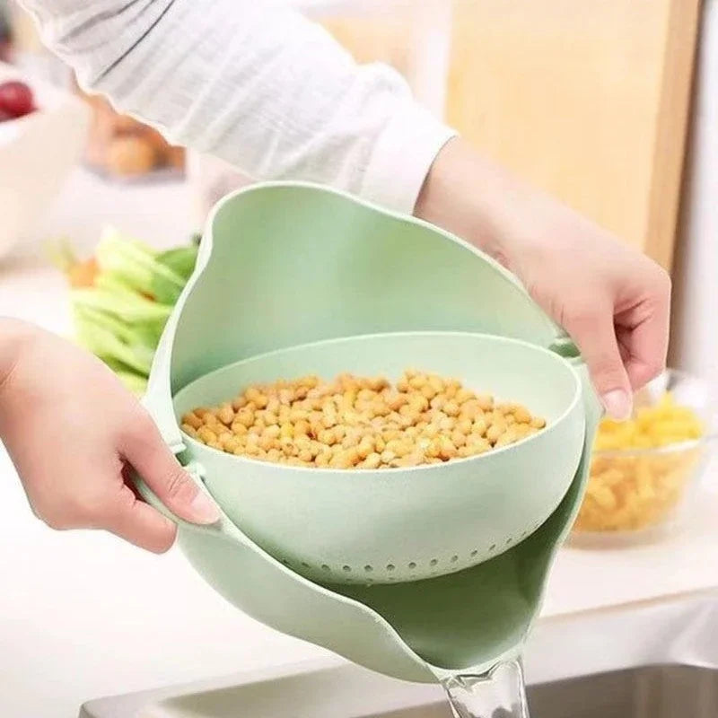 Hands holding a green double layer fruit and vegetable basket draining water from soaked chickpeas in kitchen