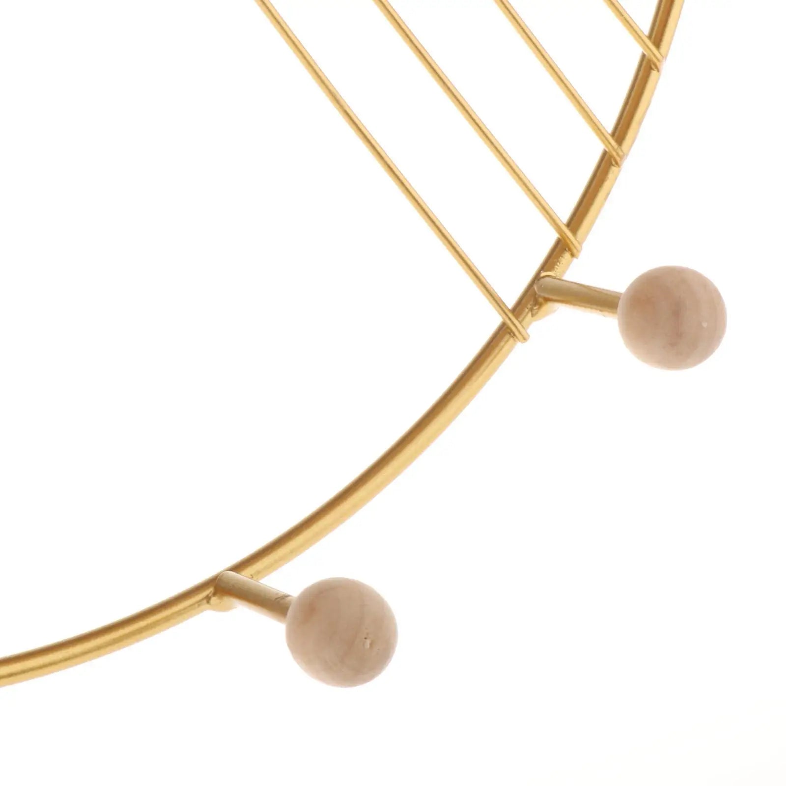 Close-up of gold metal and wooden hooks on floating wall shelf for decor by Clarify.pk