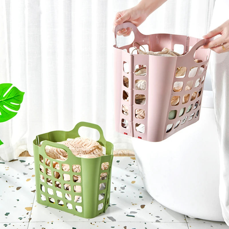 Clarify.pk foldable plastic laundry basket in green and pink filled with clothes in bright room