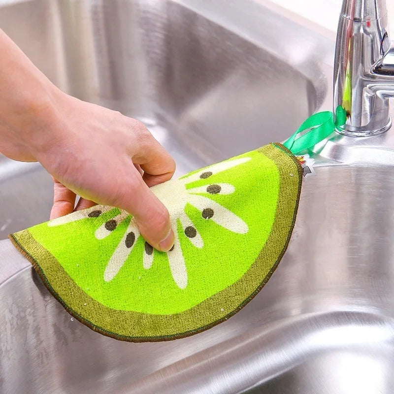 Green kiwi fruit shape microfiber dishcloths being used to clean stainless steel sink faucet
