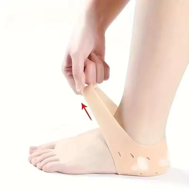 Beige silicone heel socks for cracked heels being worn on foot to provide cushioning and support