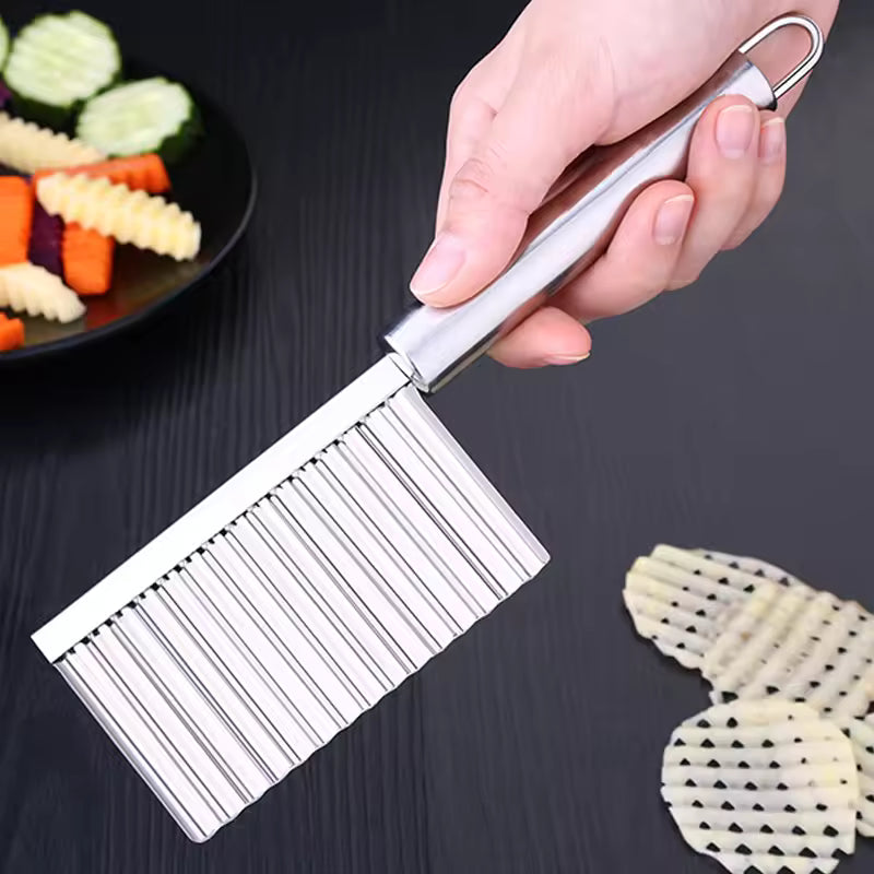 Clarify.pk stainless steel wavy potato cutter held over cut wavy potato slices and vegetables