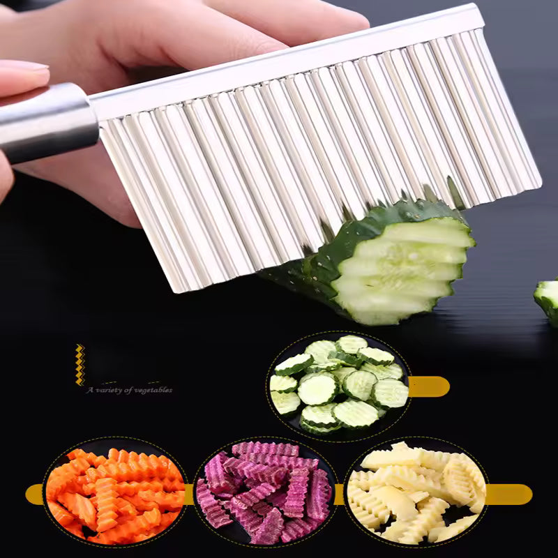 Hand holding stainless steel wavy potato cutter slicing cucumber with crinkle cuts in front of sliced vegetables