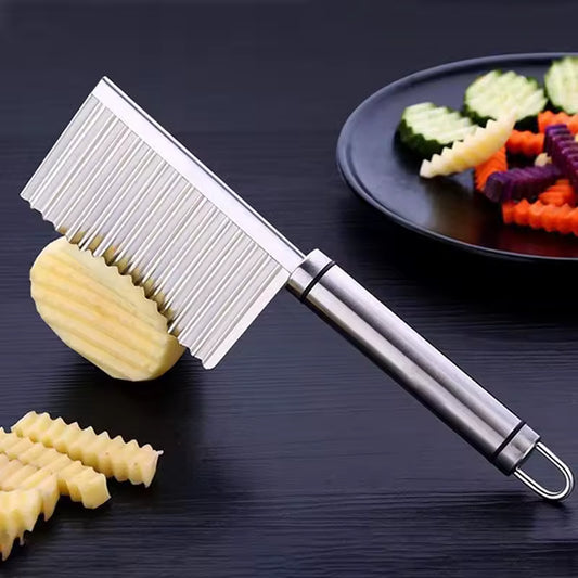 Clarify.pk stainless steel wavy potato cutter slicing crinkle-cut potatoes on black surface