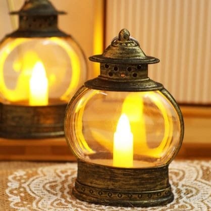 Vintage style electronic candle lantern for home decor with warm glowing light inside glass casing