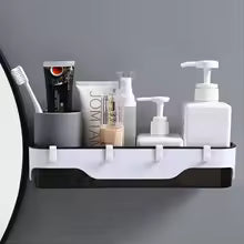 Wall-mounted bathroom shelf by Clarify.pk holding toiletries including soap dispenser and tubes