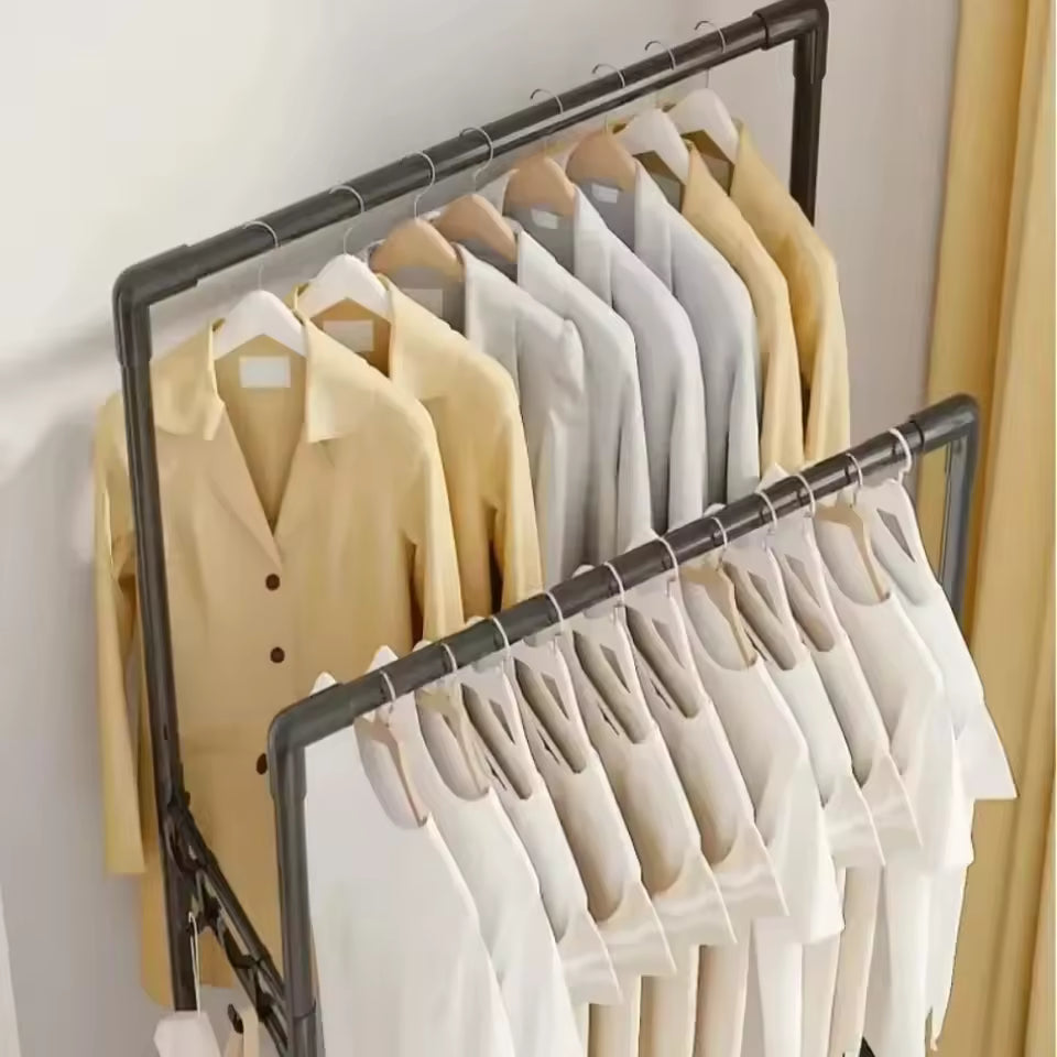 Wall mounted coat rack for living room holding beige and white shirts on wooden hangers