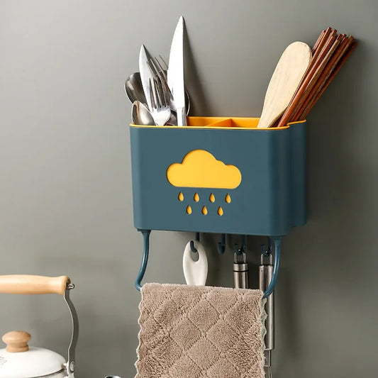 Wall mounted kitchen organizer in blue and yellow with utensils and towel hanging for kitchen storage