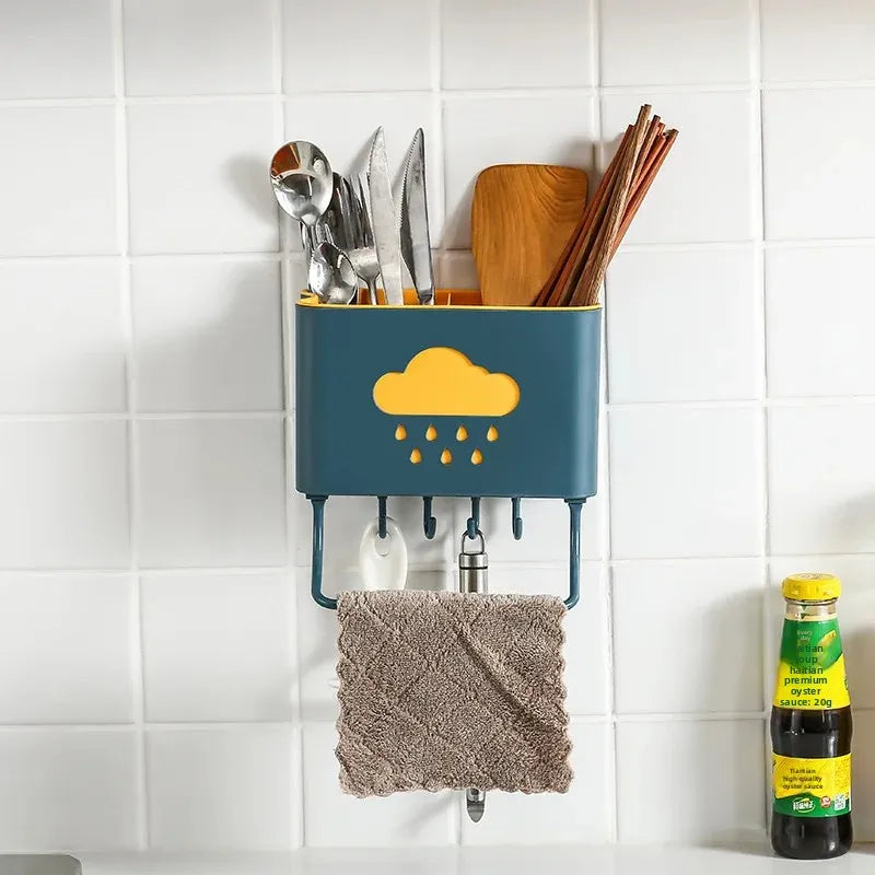 Clarify.pk wall mounted kitchen organizer in teal with yellow cloud design holding utensils and wooden spoons with hanging towel