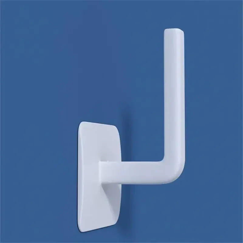 White wall mounted paper towel holder with simple modern design on blue background