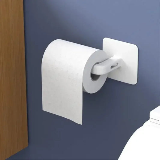 White wall mounted paper towel holder attached to blue wall next to wooden cabinet