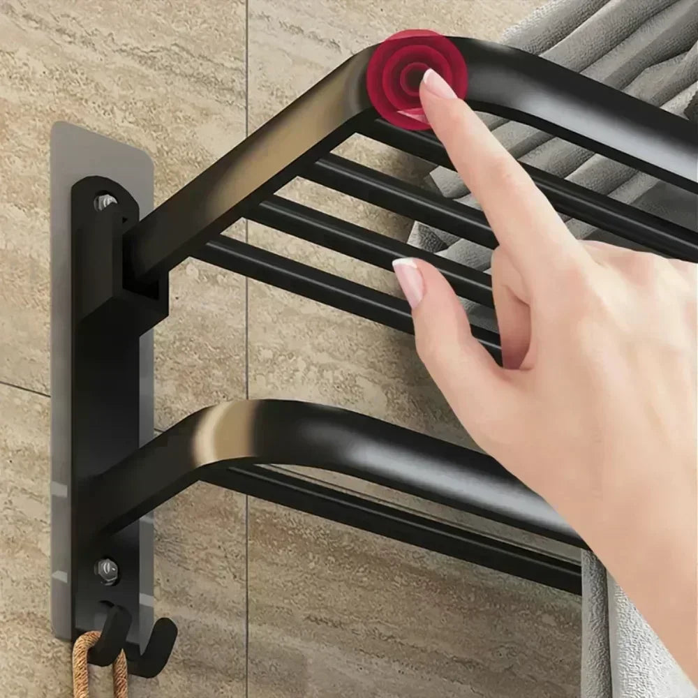 Black wall mounted shower towel rack installed on tiled bathroom wall with hand touching the rack
